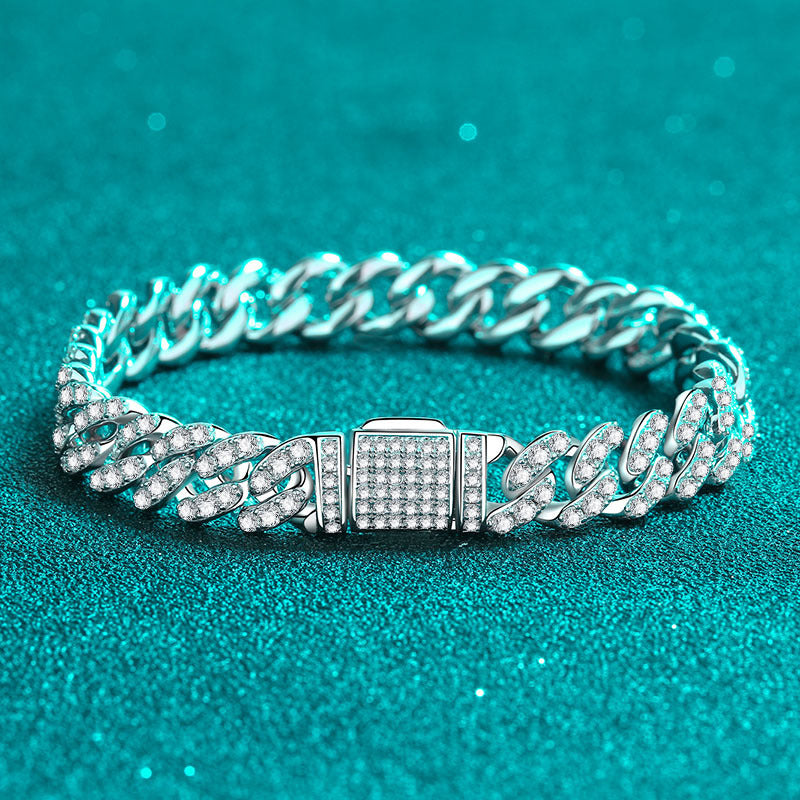 Silver chain bracelet with a clasp on a teal background