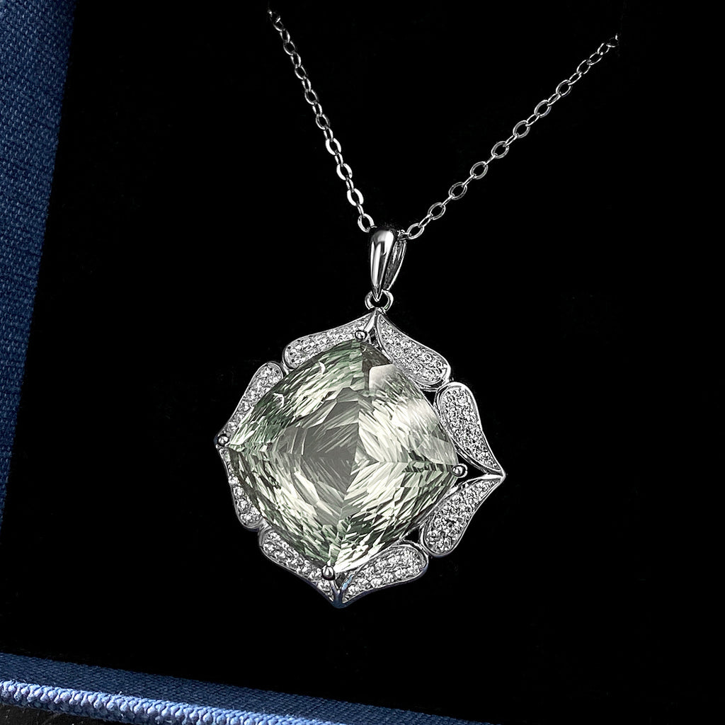 Green gemstone pendant with silver chain on a dark background