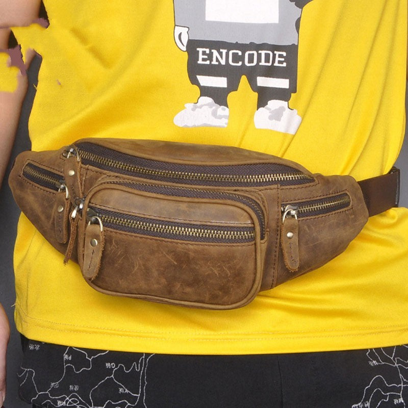 Brown leather waist bag worn by a person in a yellow shirt with 'Encode' graphic.