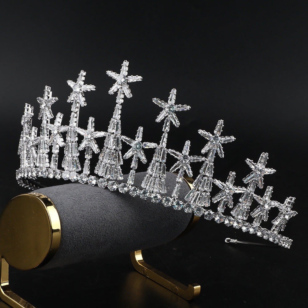 Silver tiara with star designs on a black background