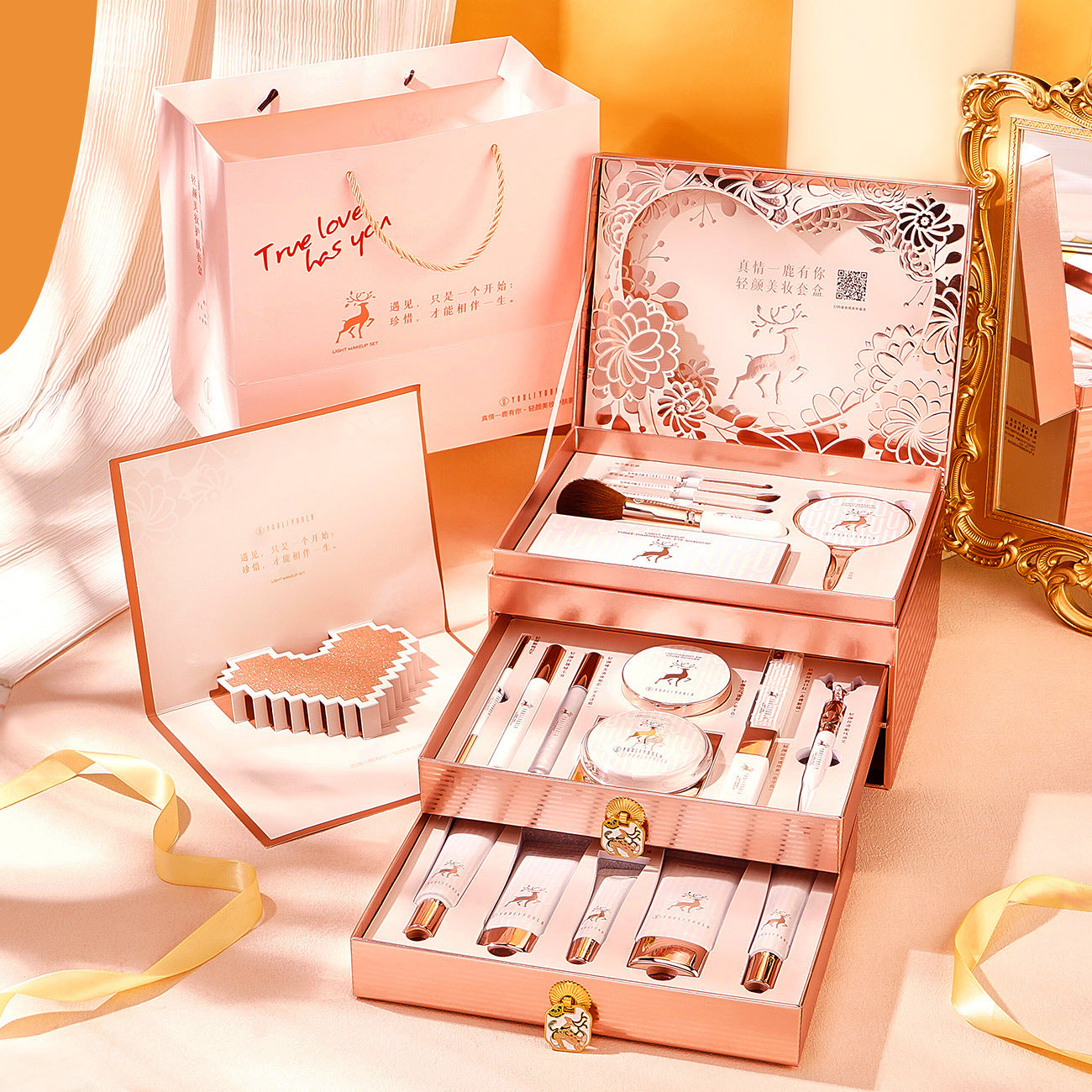 Rose gold makeup set with decorative packaging on a soft pink background