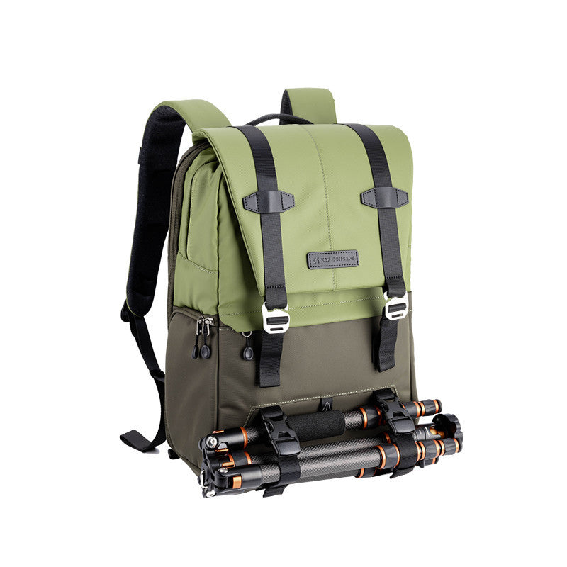 Green backpack with black straps and a camera tripod attached on a white background