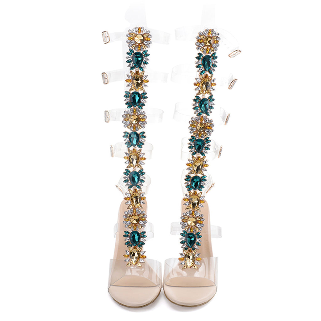 Beige high-heeled shoes with decorative multicolored embellishments on a white background