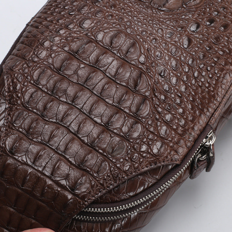 Close-up of a brown textured leather bag with a zipper on a white background
