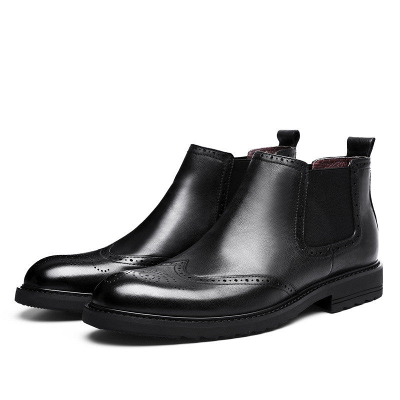 Pair of black leather Chelsea boots on a white background