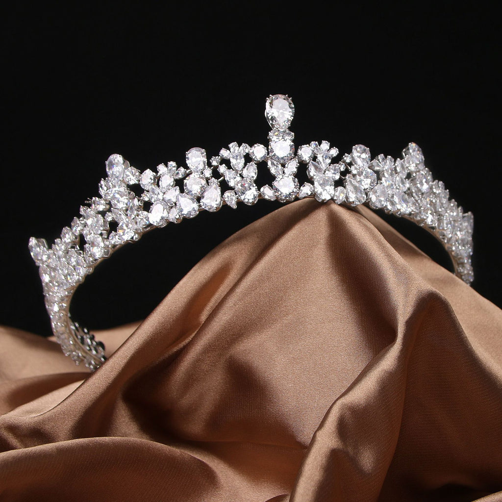 Silver tiara on a brown fabric background