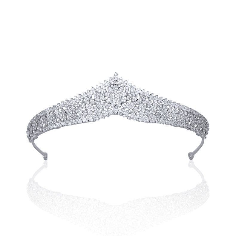 Silver tiara with sparkling stones on a white background