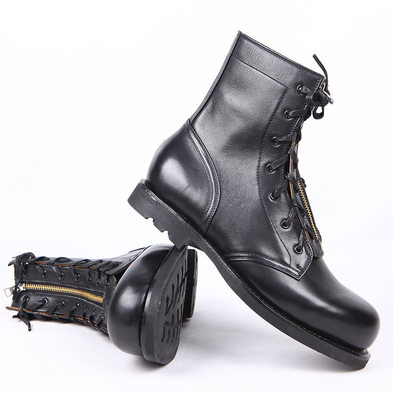 Black leather boots with gold zippers on a white background