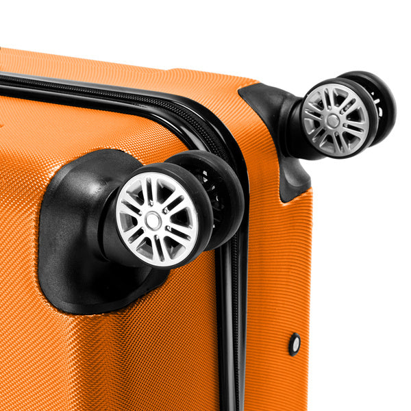 Close-up of an orange suitcase with black wheels on a white background