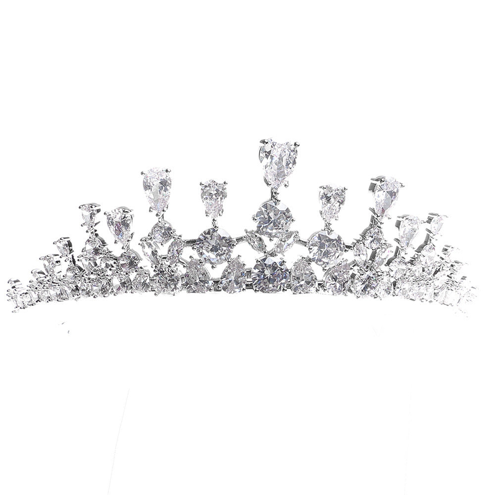 Silver tiara with clear gemstones on a white background