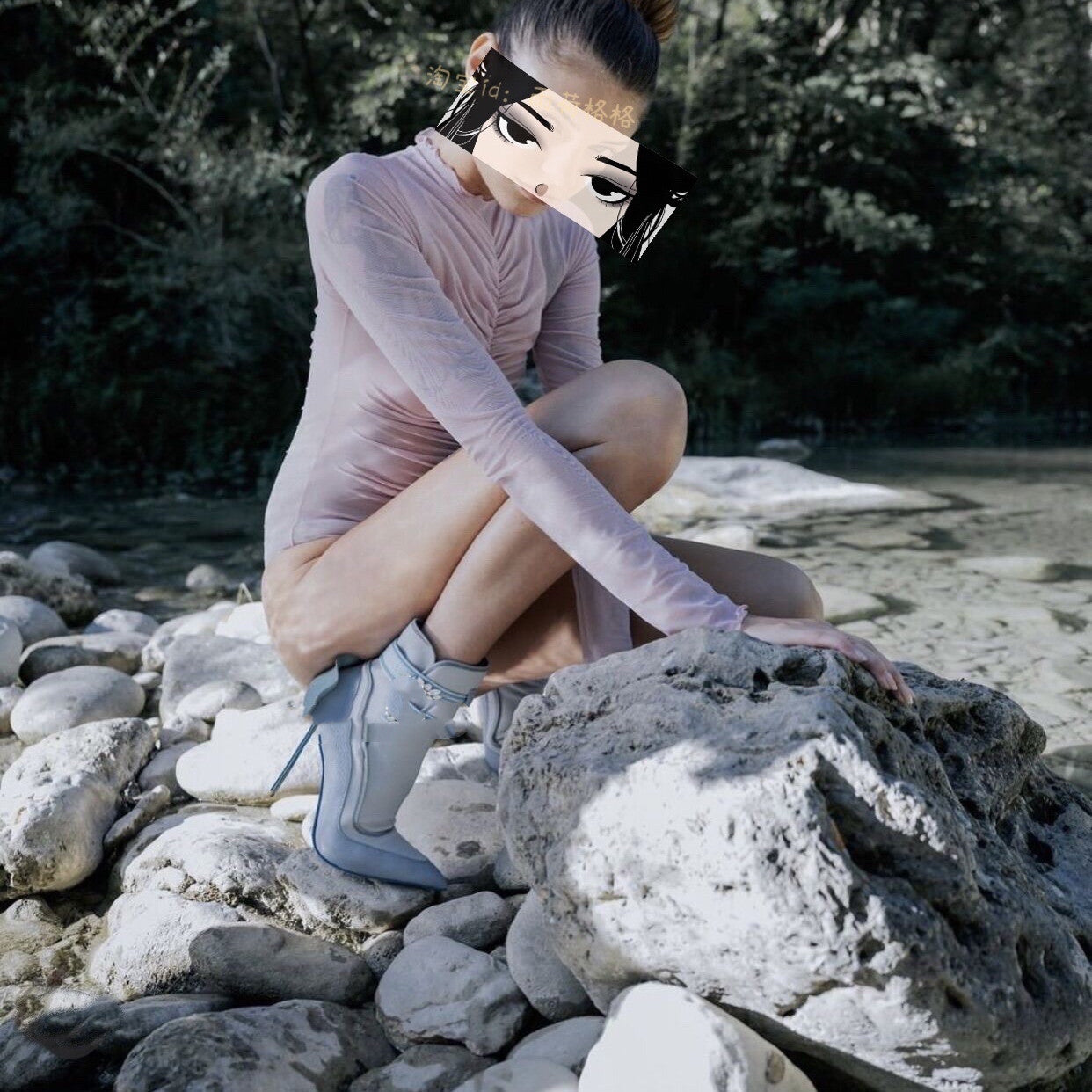 Person in a pink dress and blue high heels sitting on rocks with a blurred face.