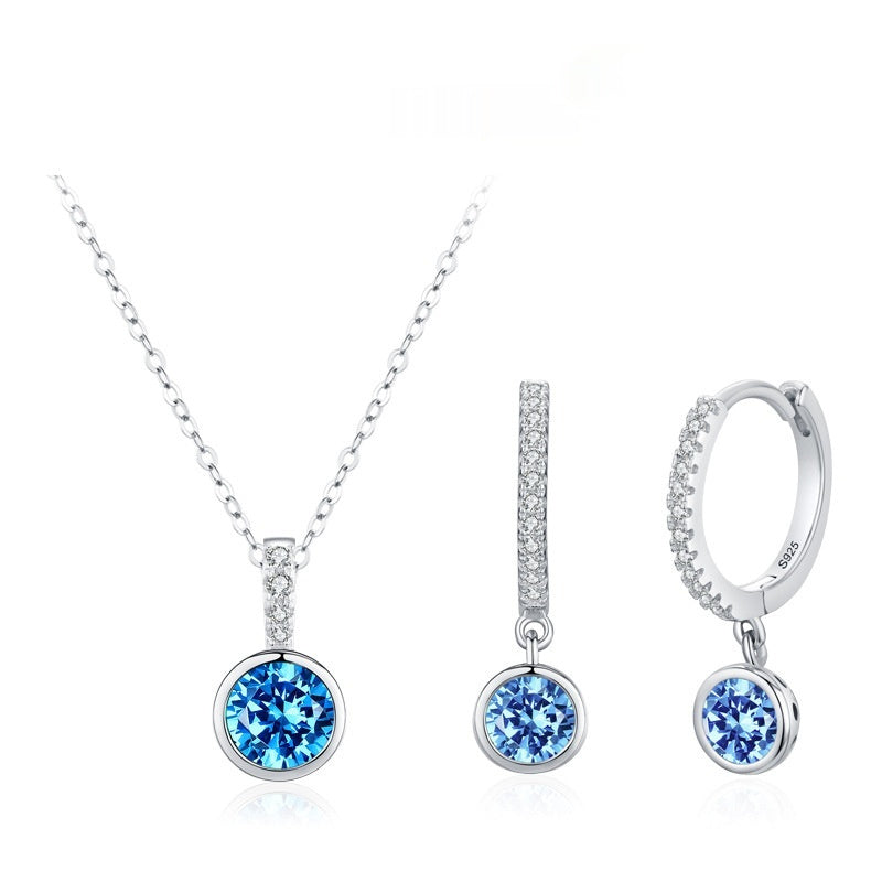 Silver jewelry set with blue gemstones on a white background