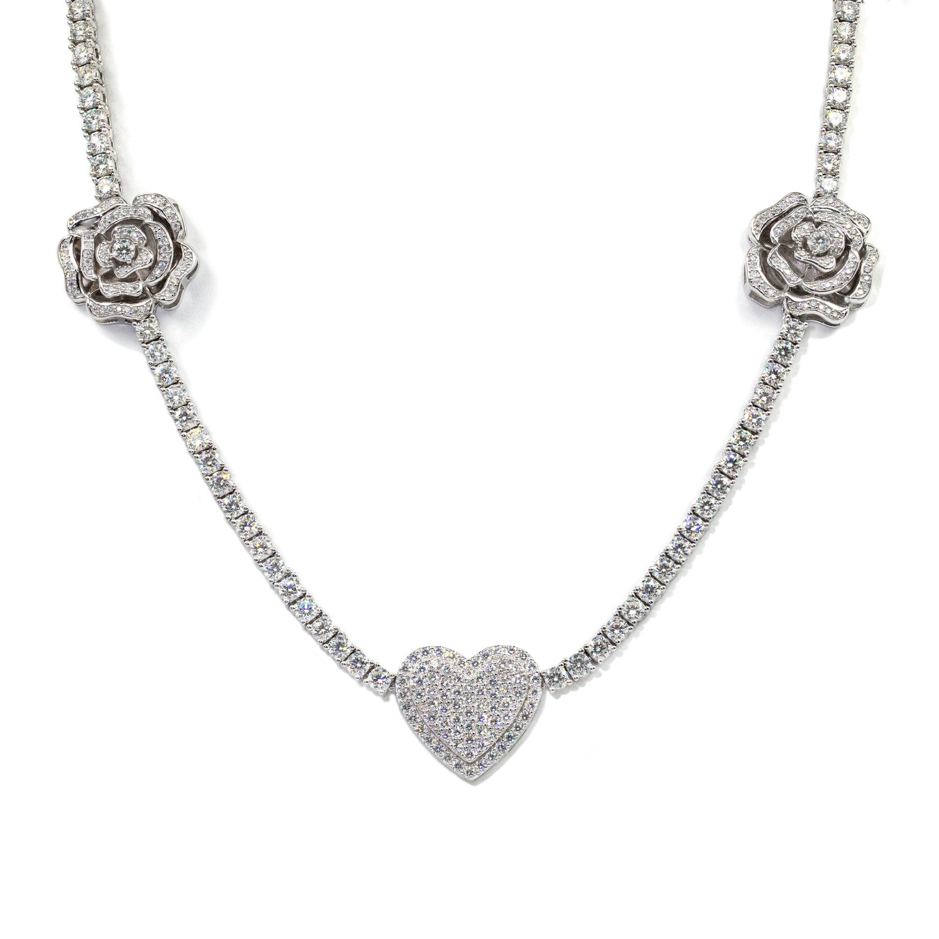 Silver necklace with rose and heart pendants on a white background