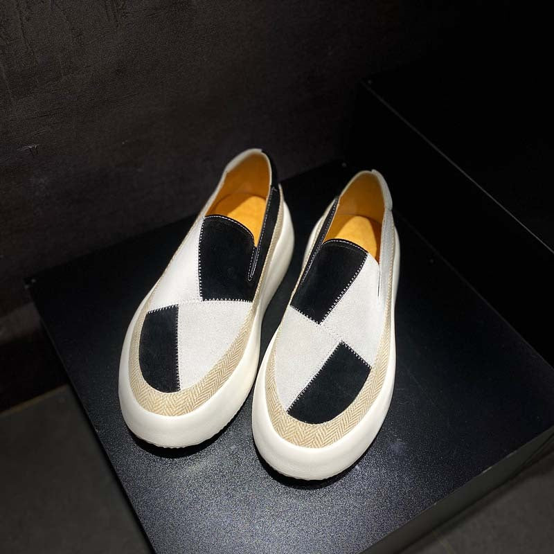 Pair of checkered loafers on a dark surface
