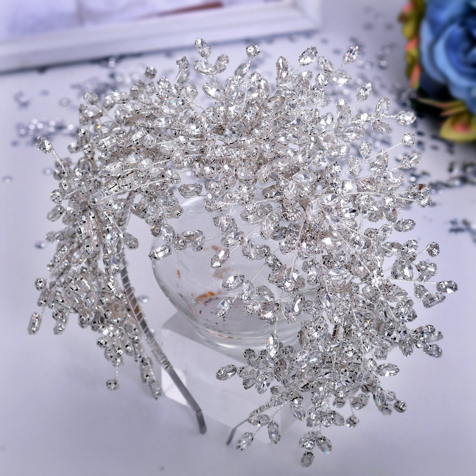 Silver hairpiece with intricate design on a white surface