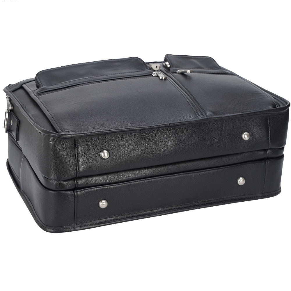 Black leather suitcase with silver zippers on a white background