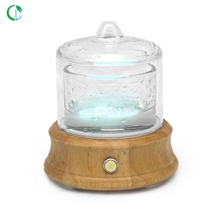 Glass container with wooden base on a white background