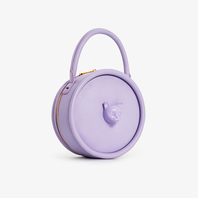 Lavender handbag with a handle on a light gray background