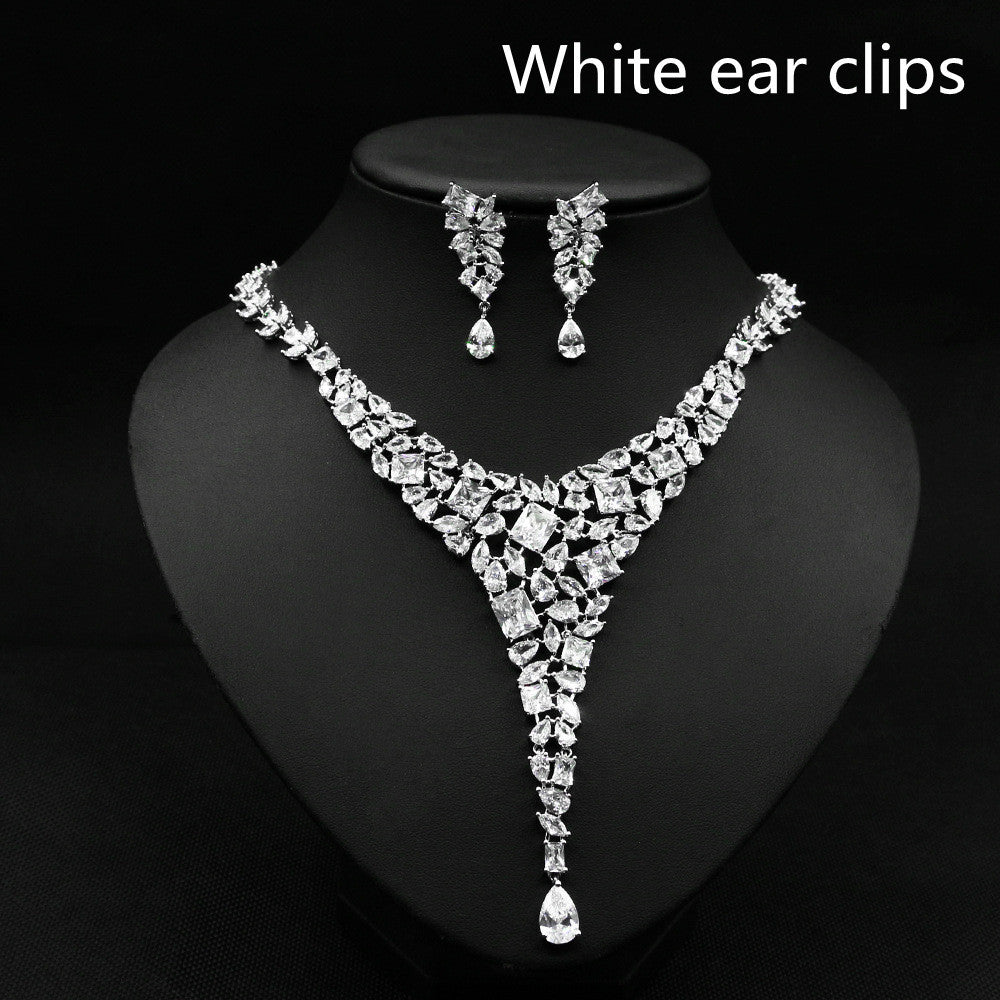 Jewelry set with necklace and earrings on a black stand, labeled 'White ear clips'.