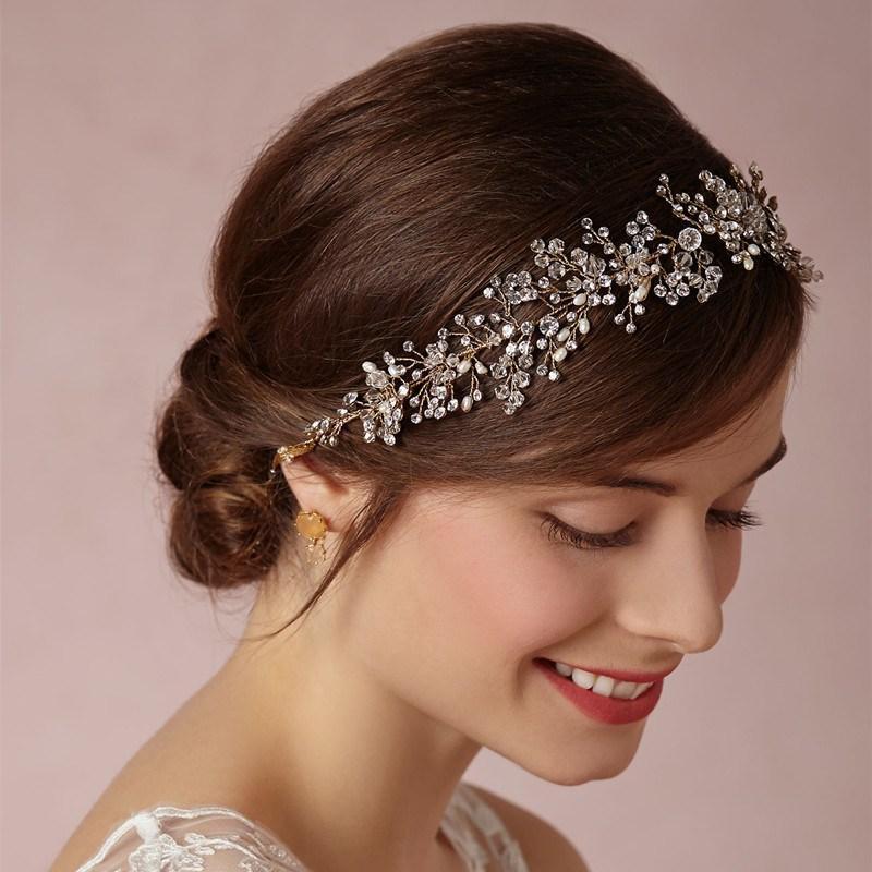 Woman wearing a decorative headband with a soft pink background