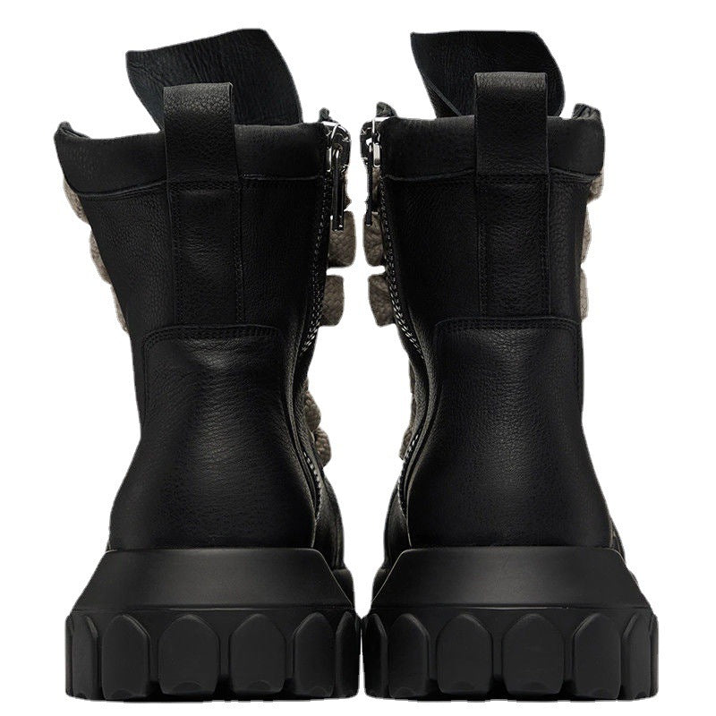 Pair of black combat boots on a white background