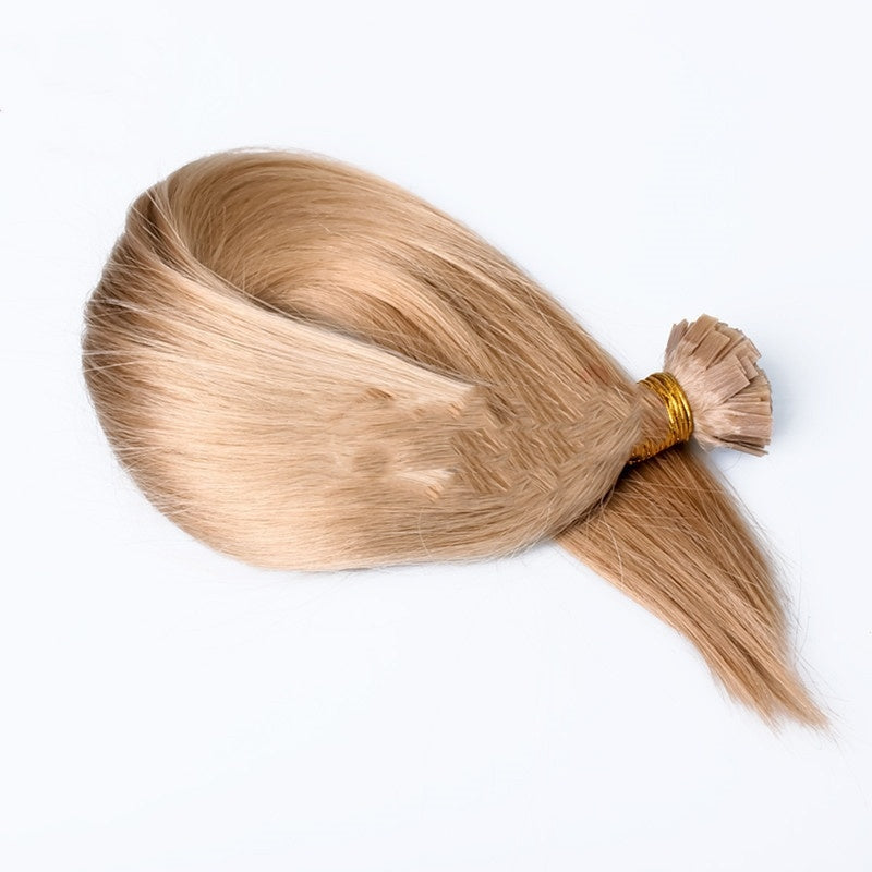 Blonde hair extension tied in a ponytail on a white background