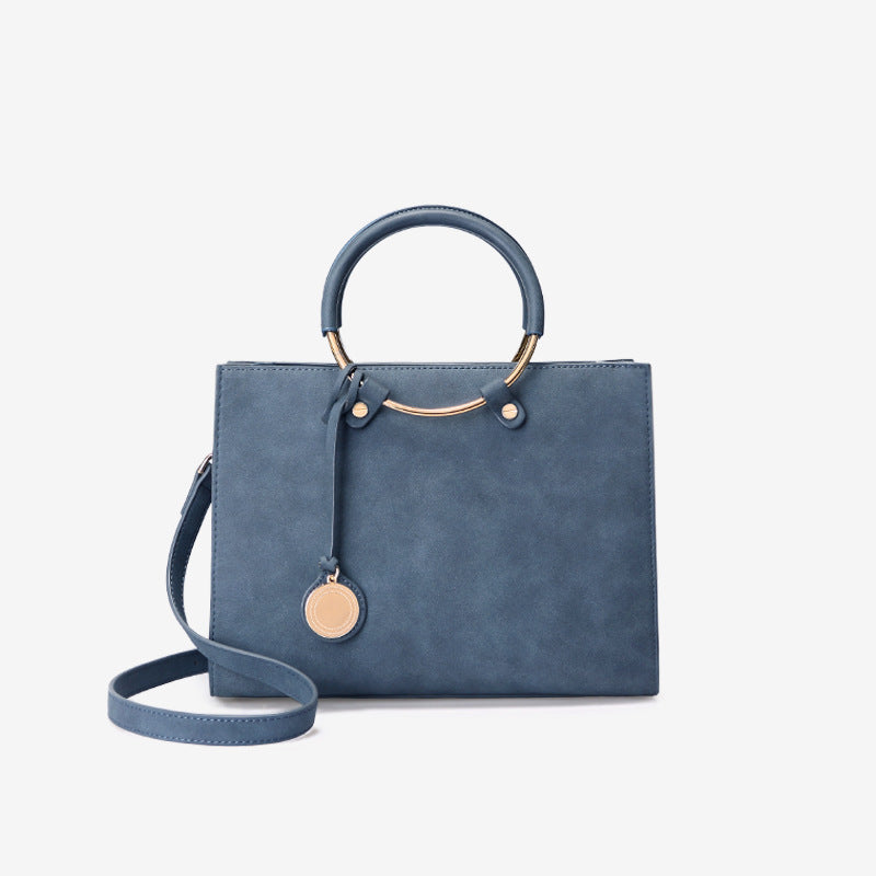 Blue handbag with a strap on a white background