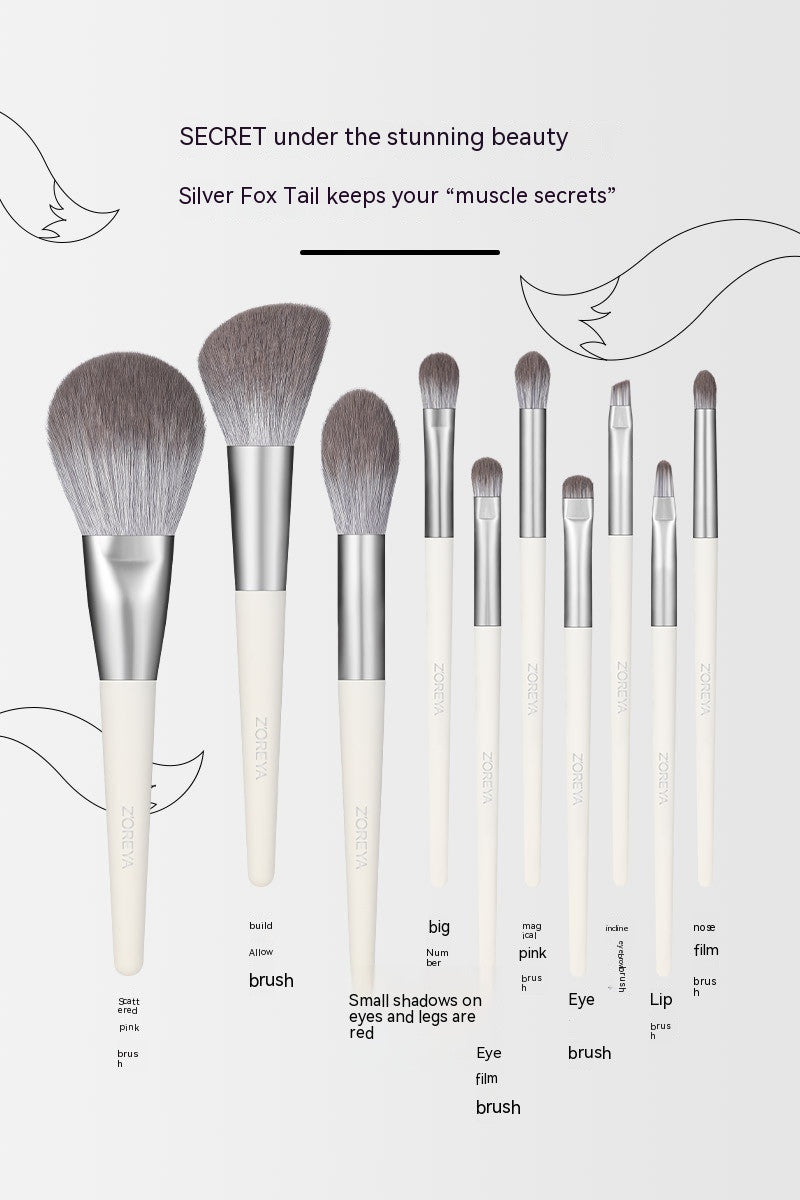 Set of makeup brushes with silver ferrules and white handles on a light gray background.