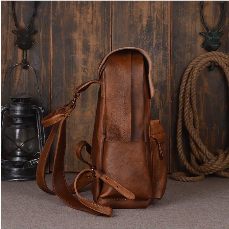 Brown leather backpack on a wooden surface with rustic decor