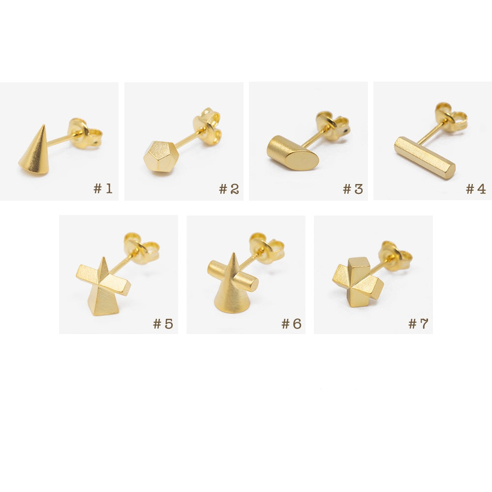 Set of gold earrings on a white background