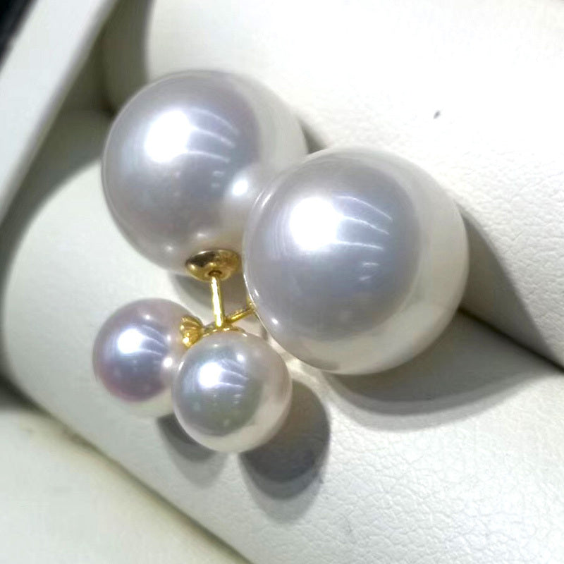 Pearl earrings on a white cushion