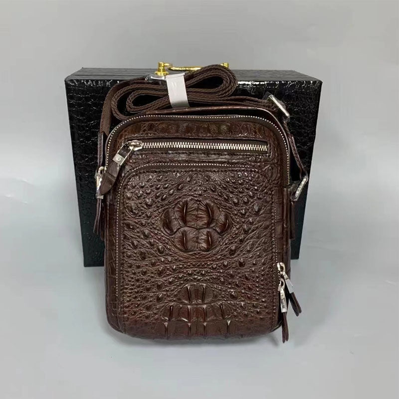 Brown textured leather bag with gold accents on a gray background