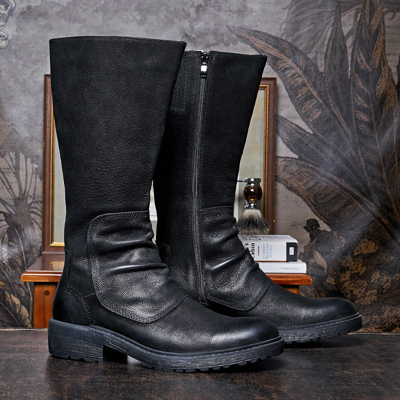Black leather knee-high boots on a textured surface with a decorative background