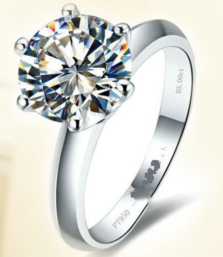 Silver ring with a large diamond on a light background