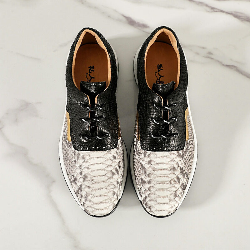Pair of black and white patterned shoes on a marble surface