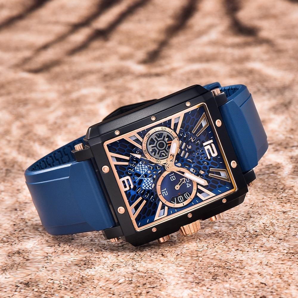 Luxury watch with blue strap and intricate design on a textured surface