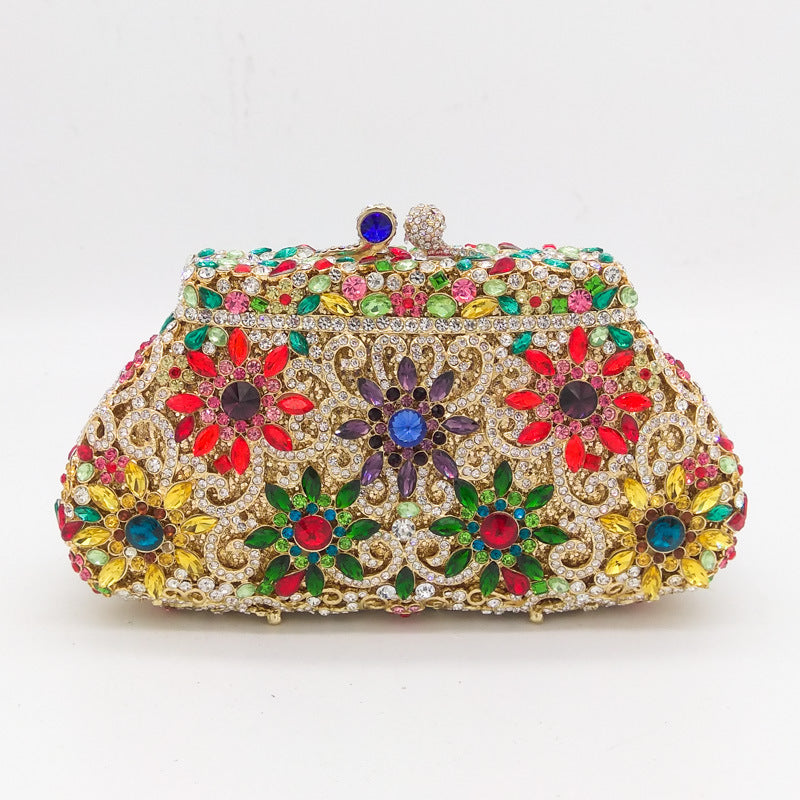 Decorative clutch bag with floral patterns and colorful gemstones on a white background