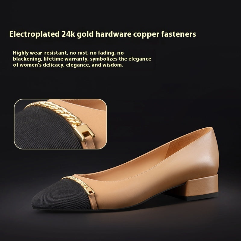 Beige and black shoe with gold hardware on a dark background