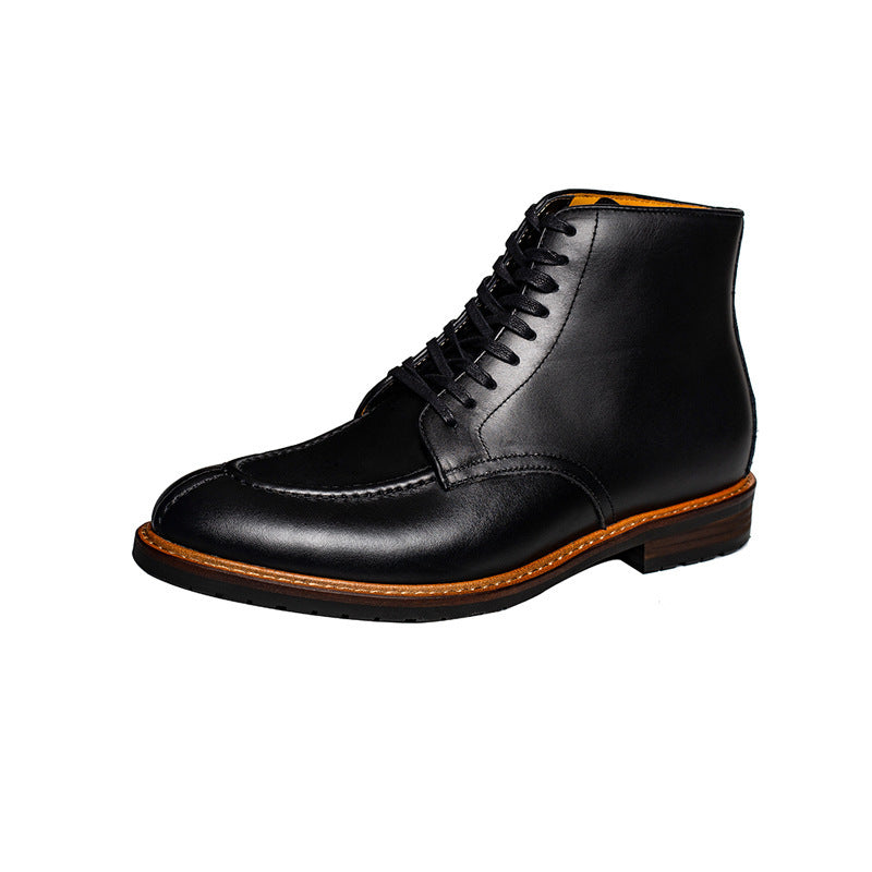 Black leather boot with brown sole on a white background