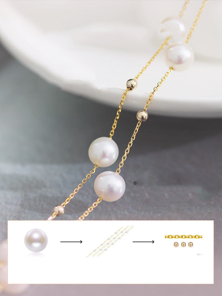 Pearl necklace with gold chain on a neutral background