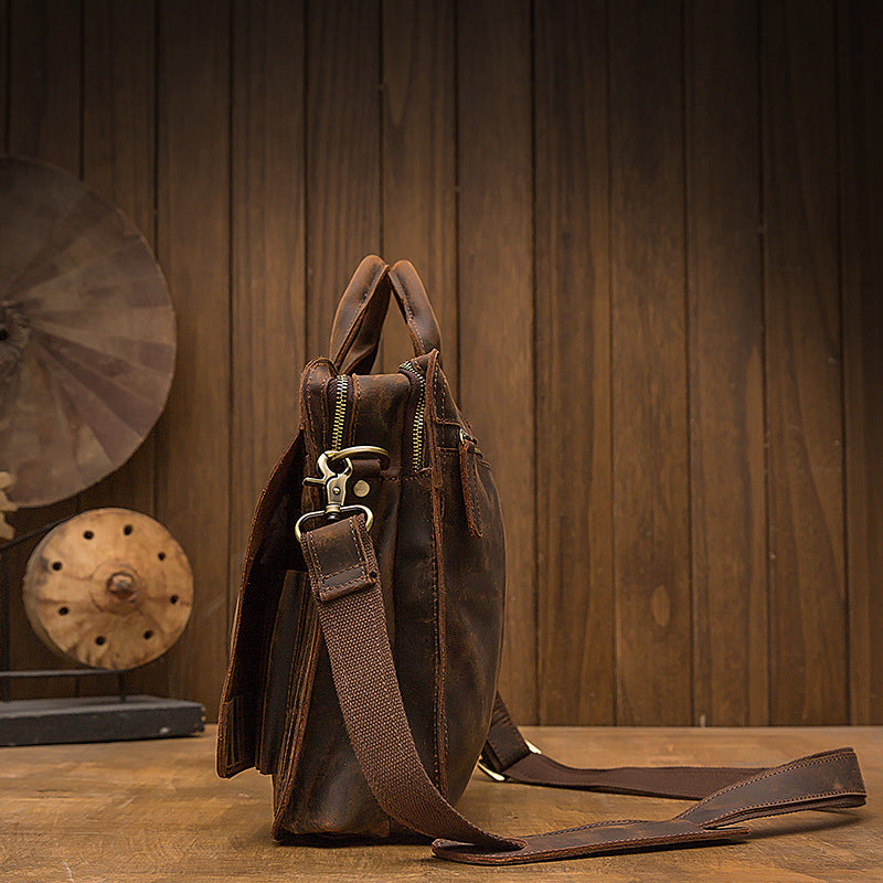 Brown leather backpack on a wooden surface with a wooden background
