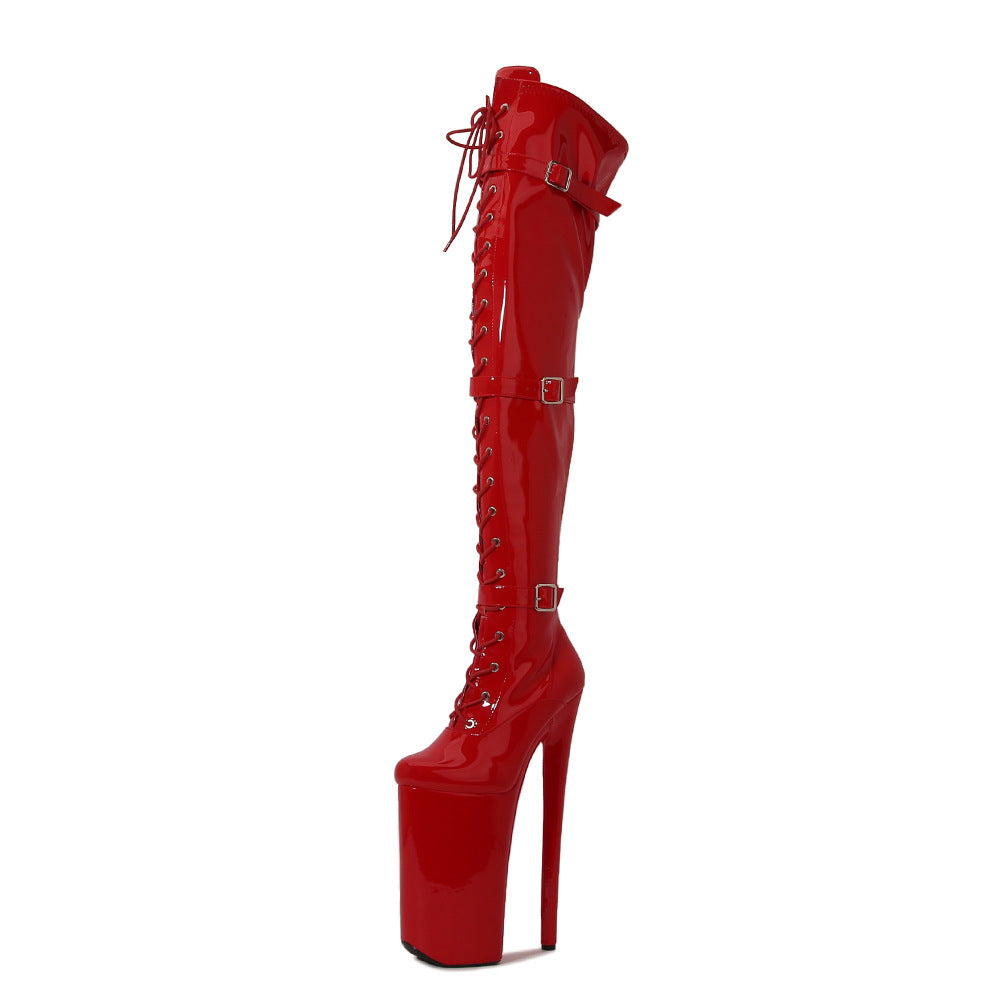 Red high-heeled platform boot with lace-up design on a white background