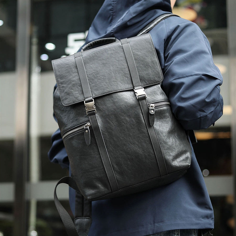 Person wearing a gray backpack with a blurred background