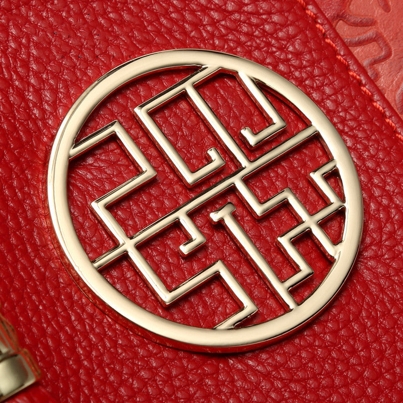 Gold geometric design on a red textured surface