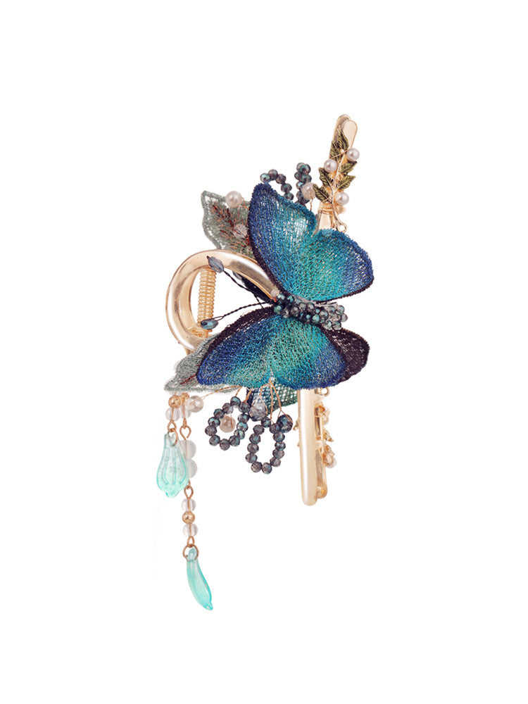 Decorative keychain with butterfly design on a white background