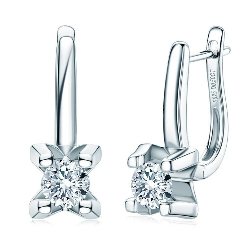 Pair of silver earrings with clear gemstones on a white background
