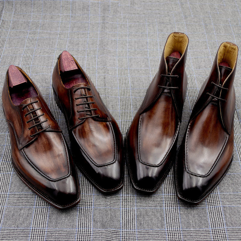 Pair of brown dress shoes on a textured gray surface