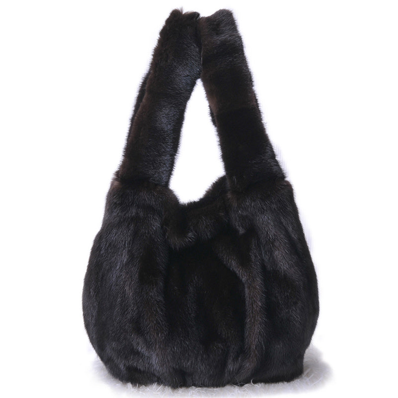 Black fur handbag on a white background
