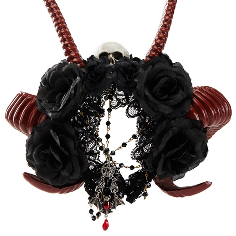 Decorative headband with black roses, red accents, and intricate detailing on a white background