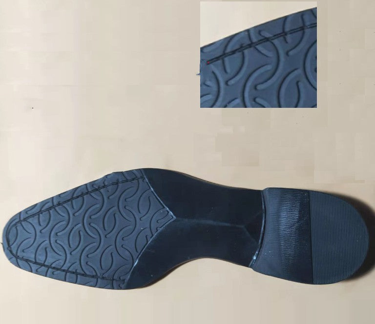 Close-up of a blue shoe sole with tread pattern on a beige background
